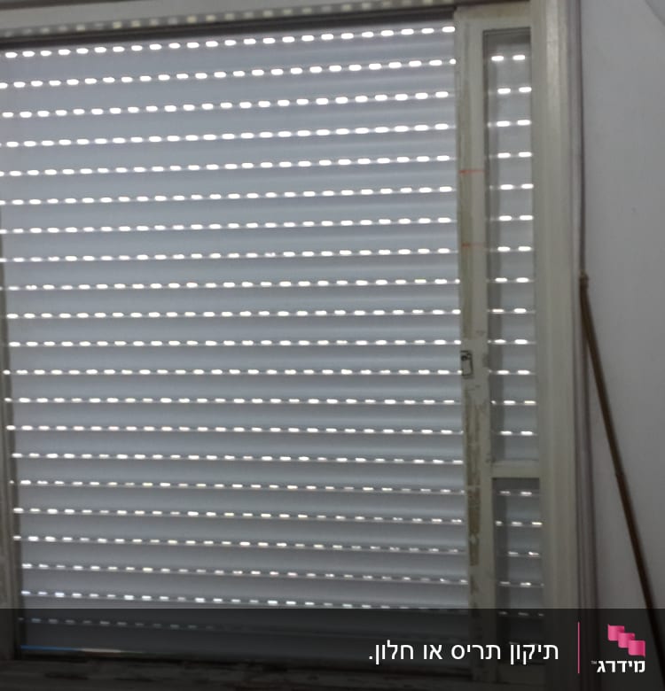 תריסים סגורים עם חריצים לאור בחלון